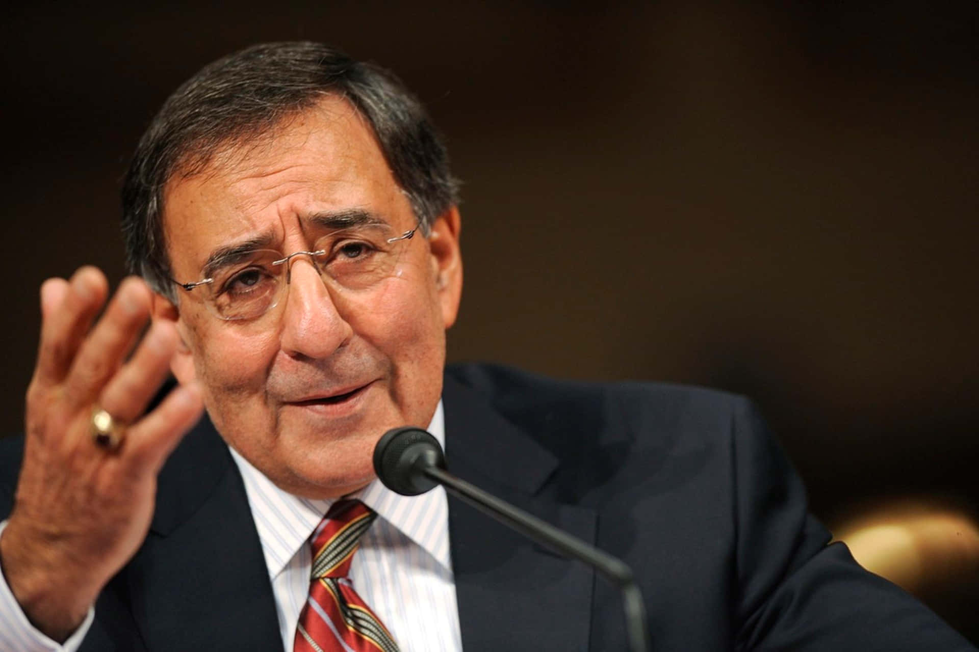 Leon Panetta Gesturing With Hand Background