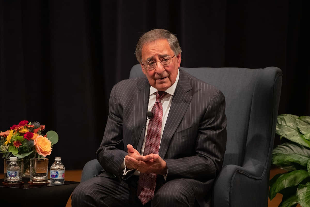 Leon Panetta On Chair Talking Background