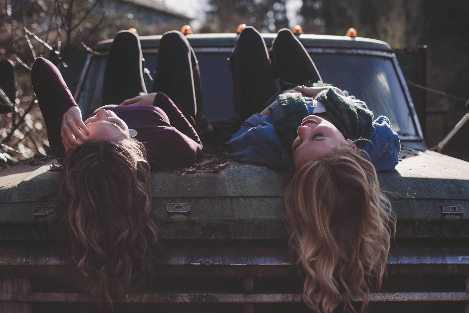 Lesbian Couple Laying On Truck Background