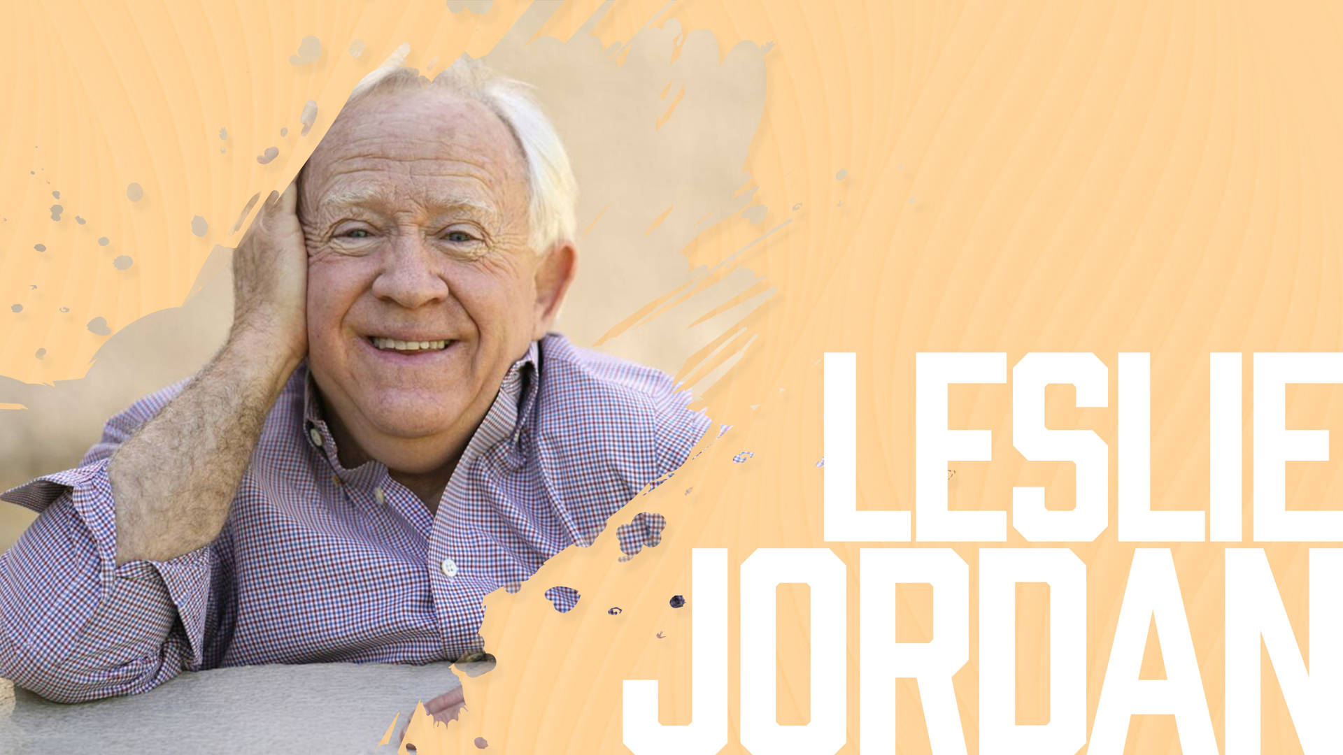 Leslie Jordan Exuding Charm Against A Yellow Background Background