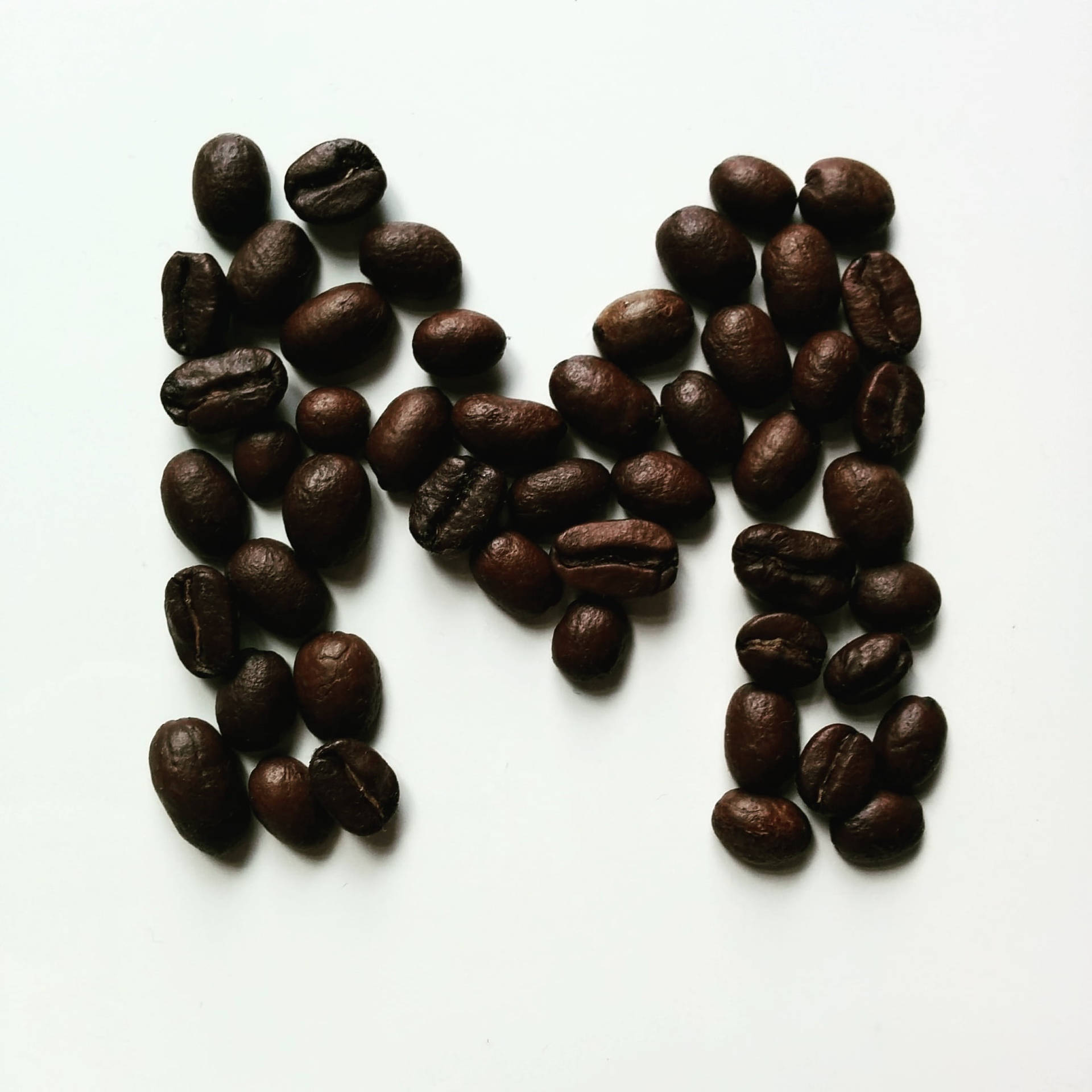 Letter M Formed With Coffee Beans