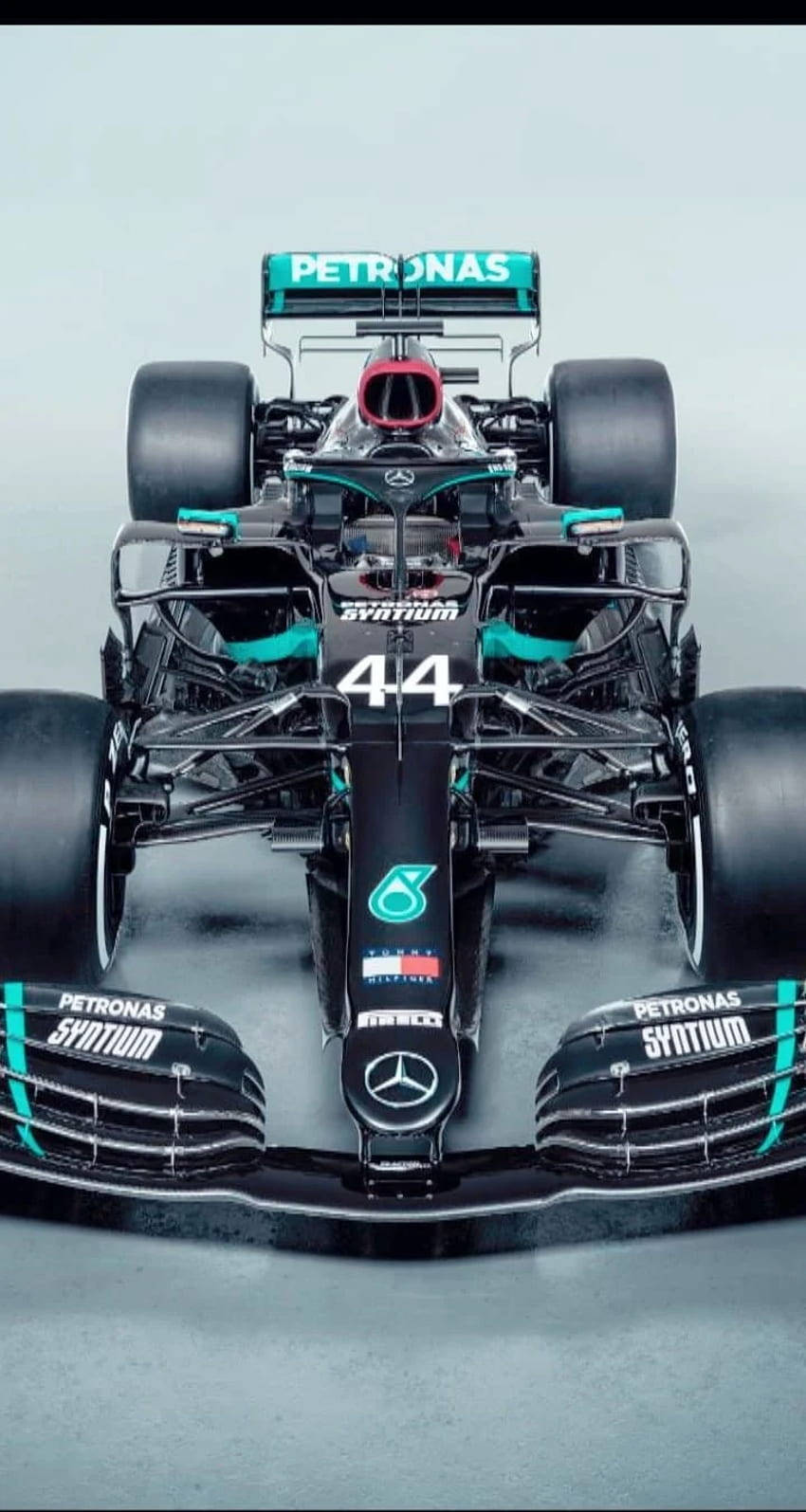 Lewis Hamilton F1 Sitting On His Racing Car Background