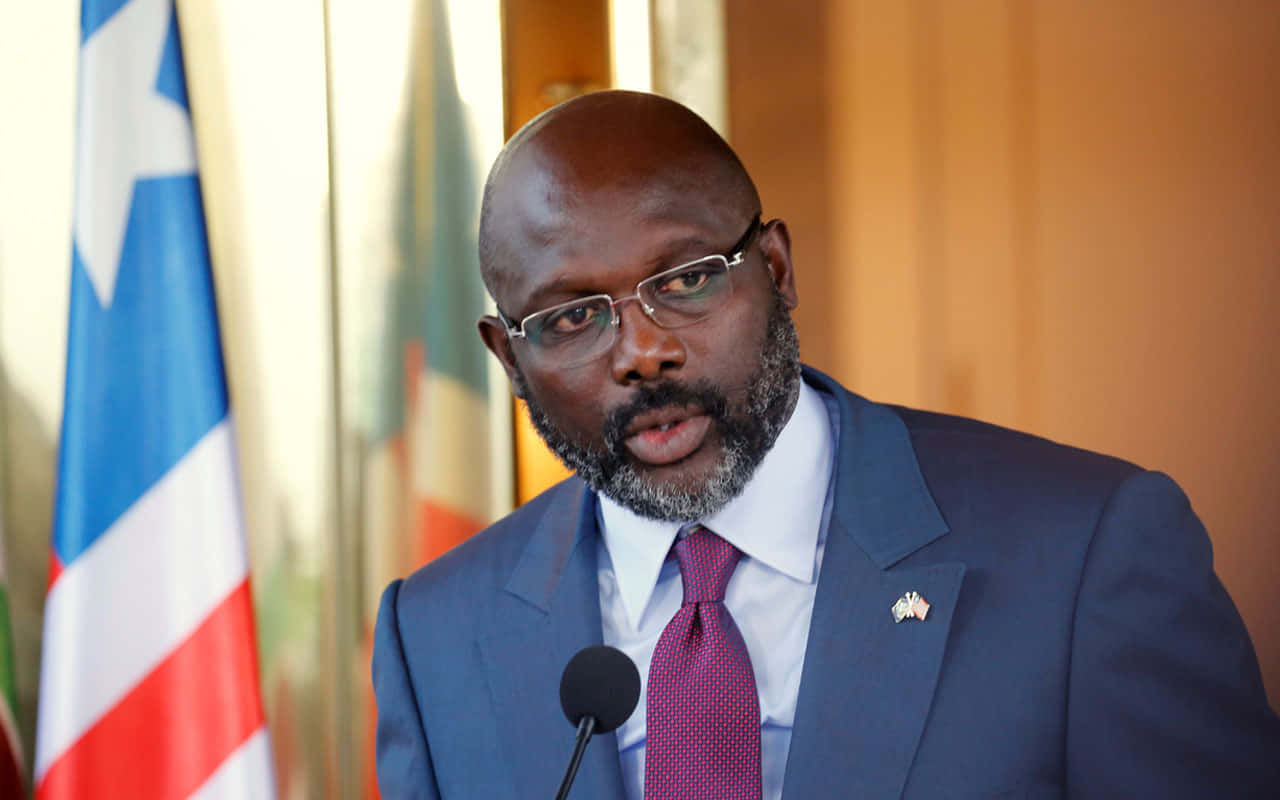 Liberian President George Weah Delivering A Speech Background