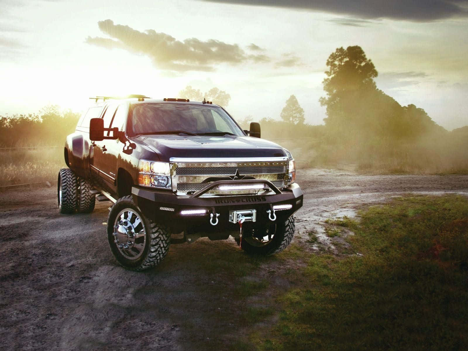 Lifted Truck On A Dirt Road Background