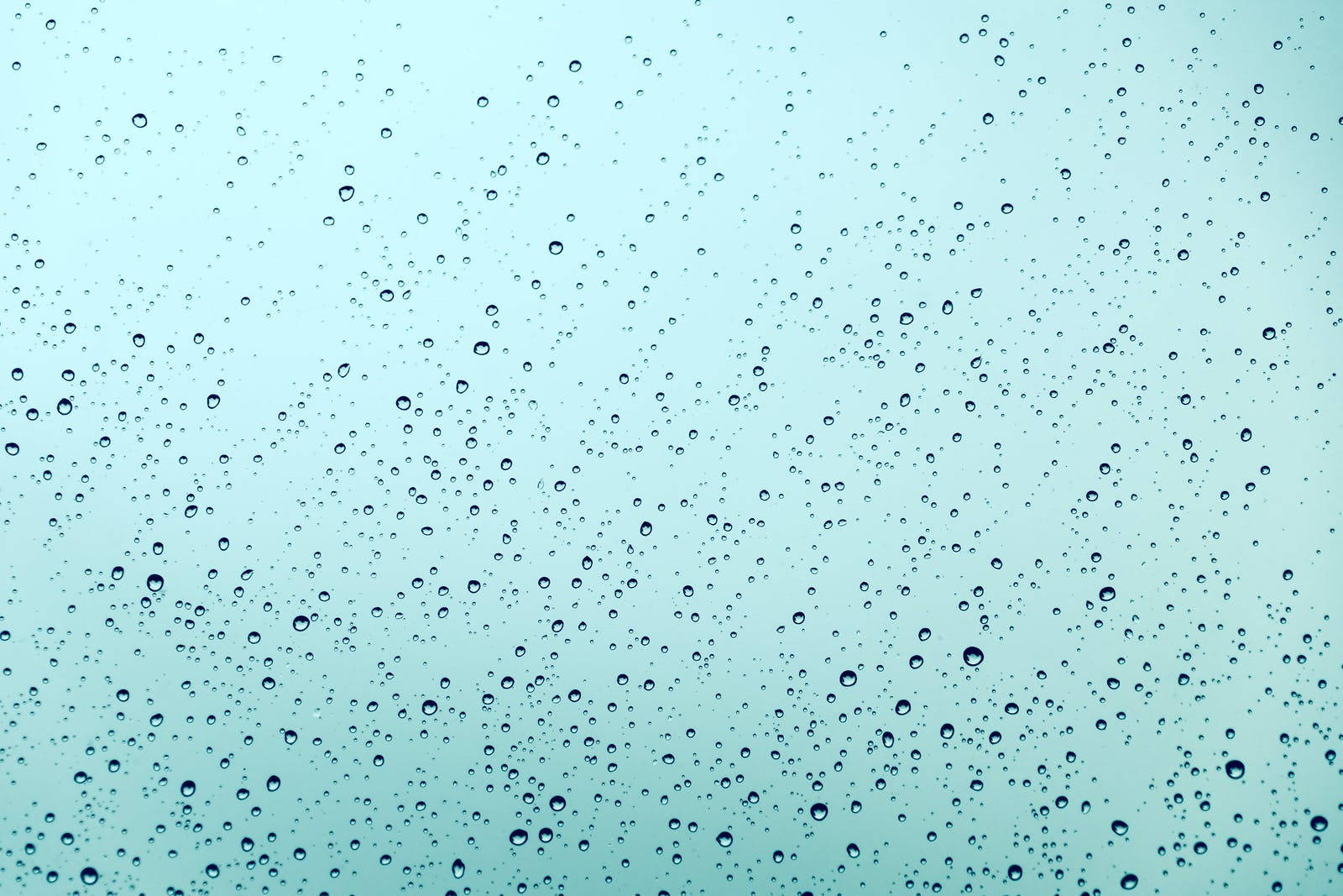 Light Blue Water Droplets On Glass Background