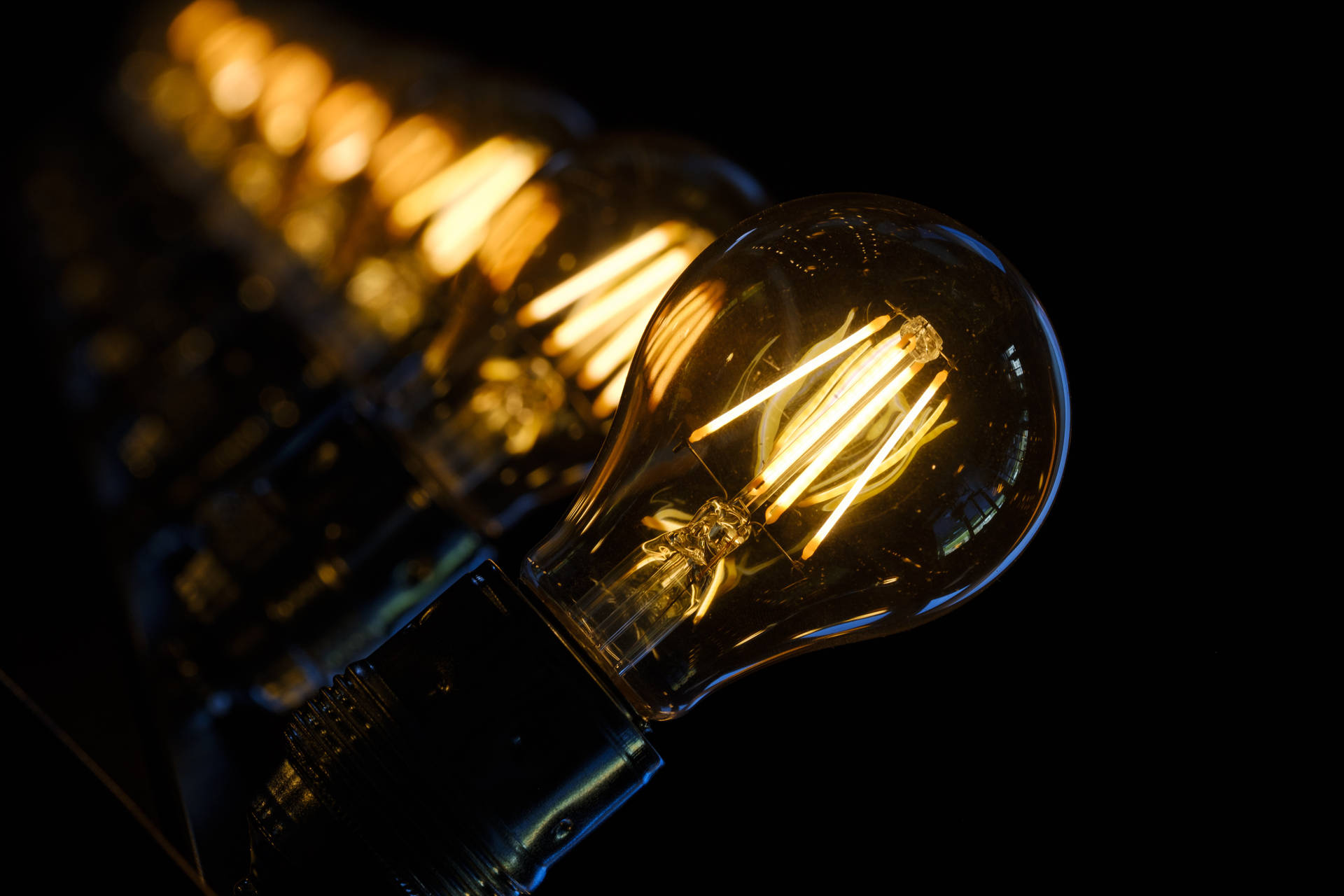 Light Bulbs With Golden Filaments Background