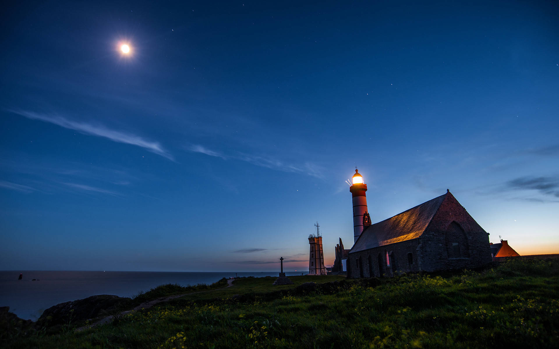 Light House In Moonlight Oceanside Background