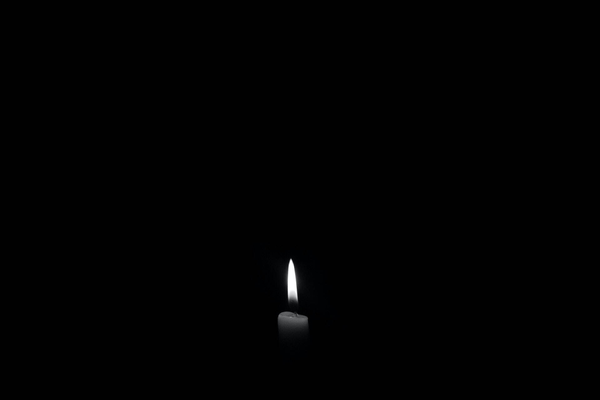 Lighted Candle On Black Pc Background