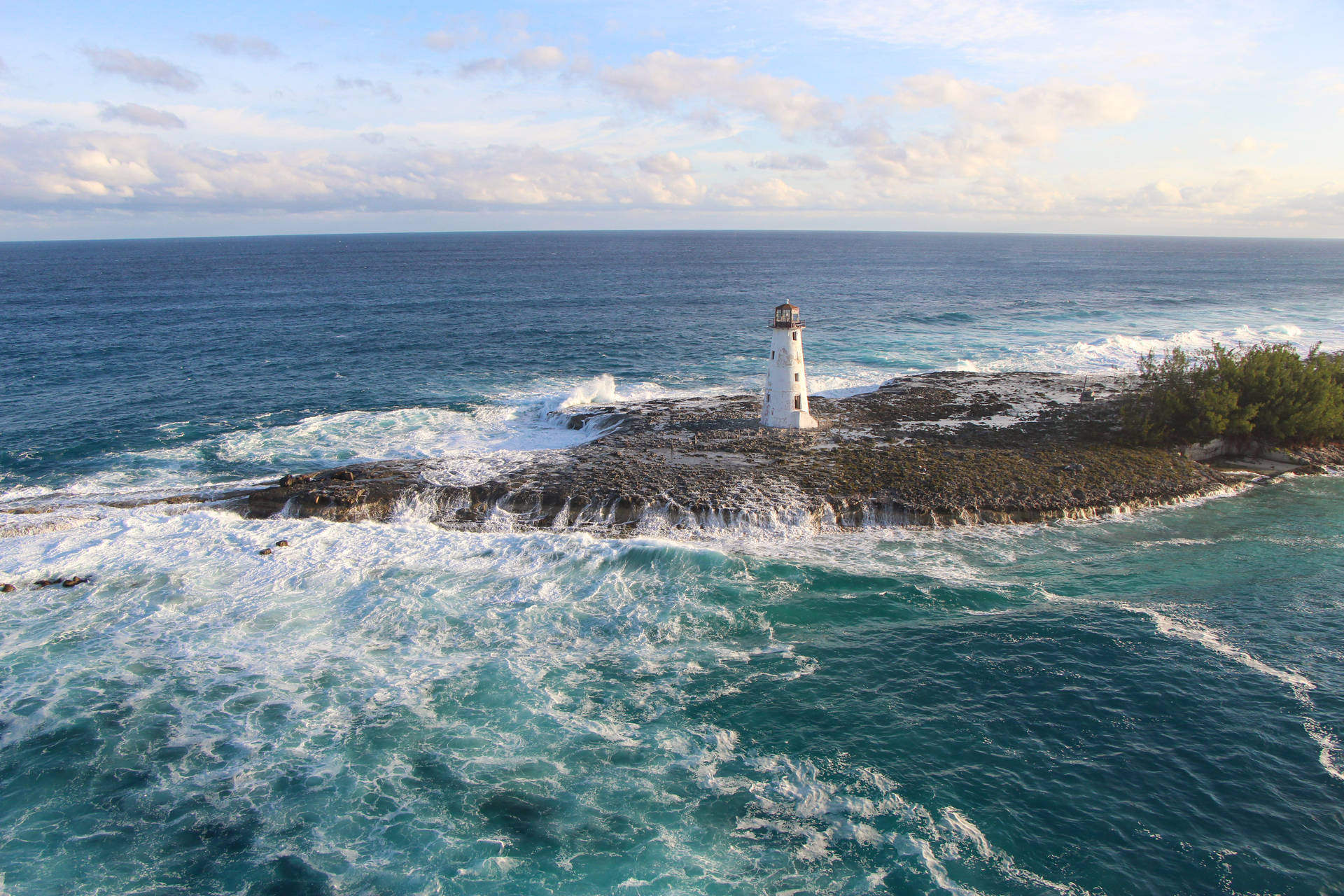 Lighthouse And Waves In Bahamas Background