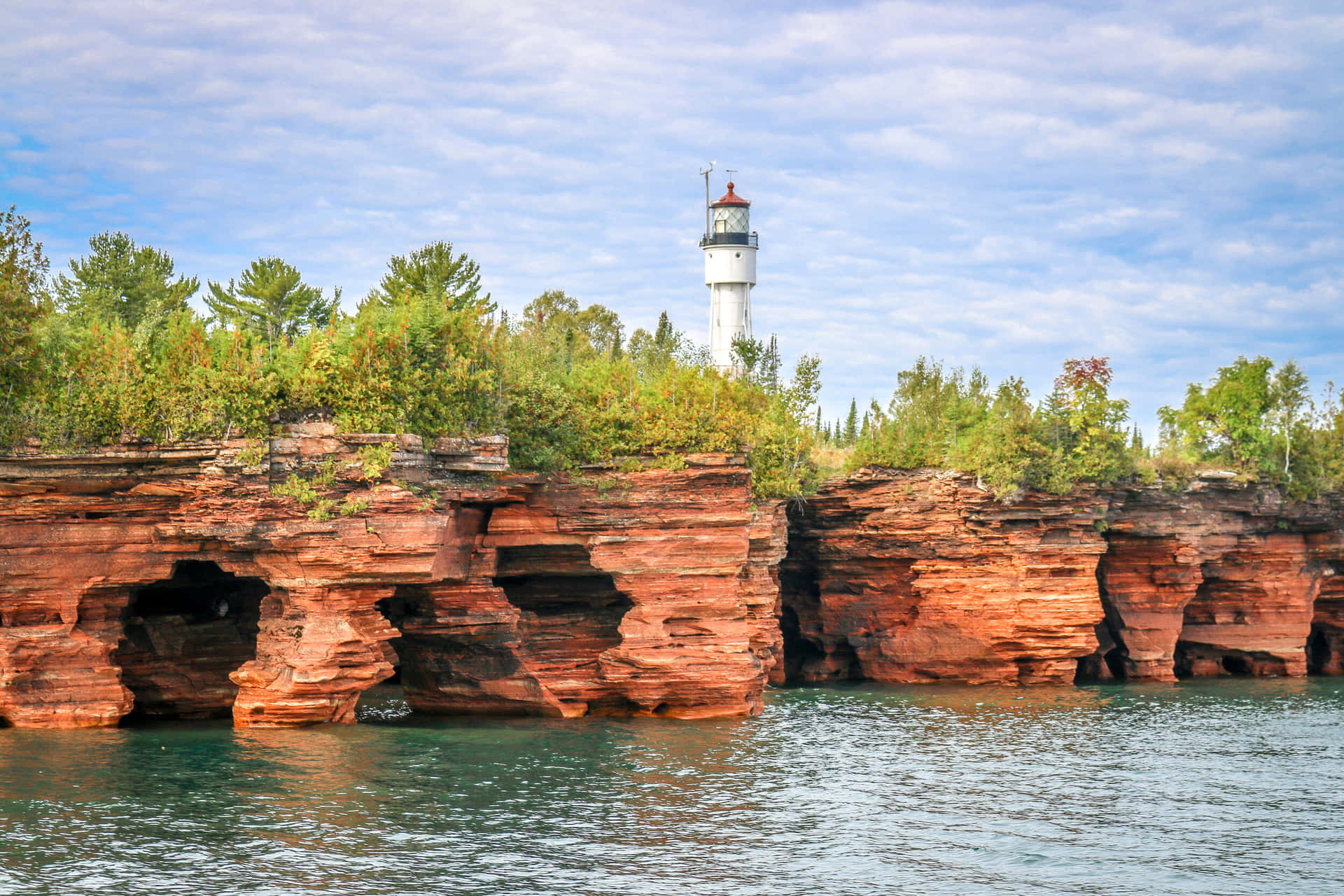 Lighthouse_ Atop_ Red_ Cliff_ Formations Background