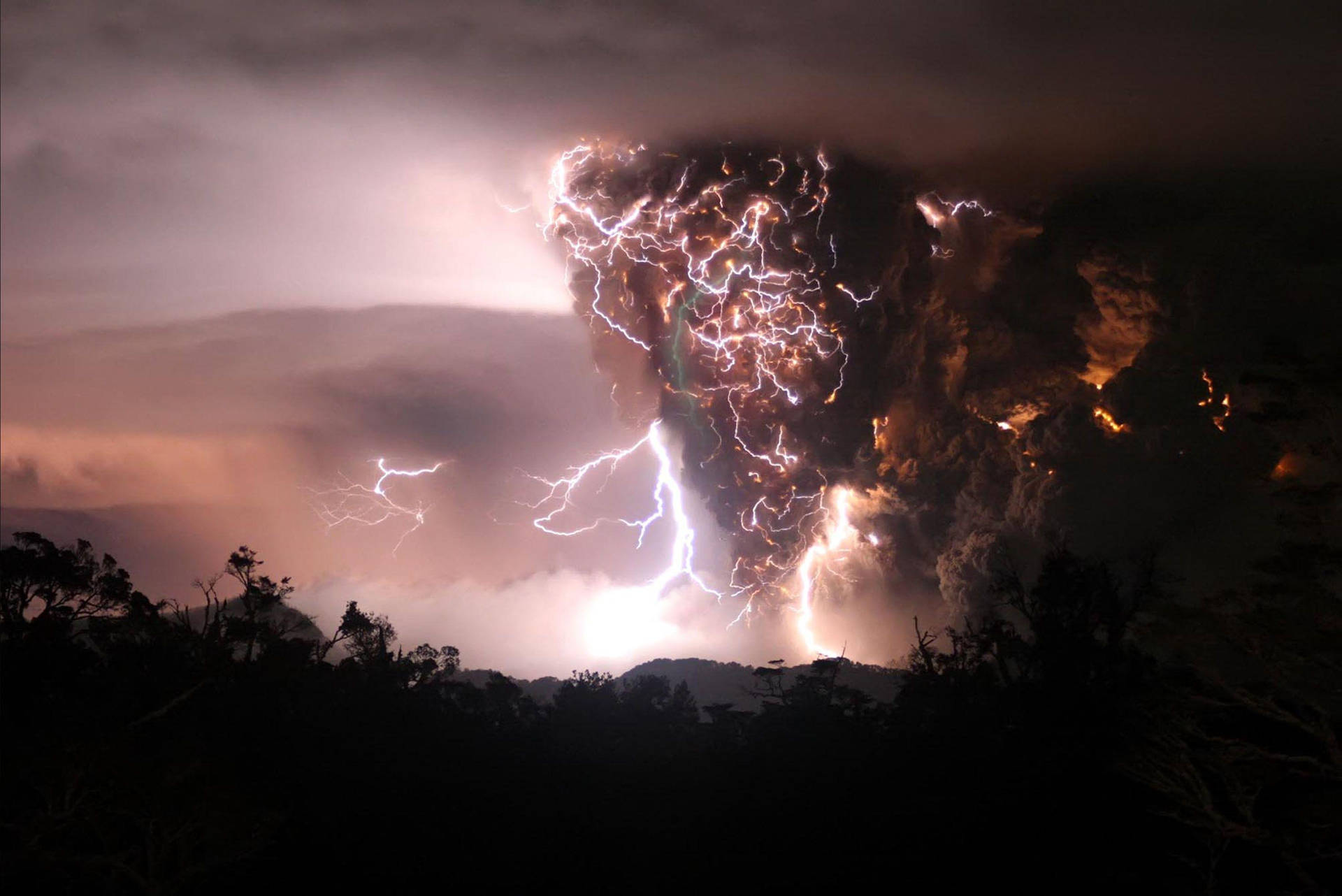 Lightning Strikes Over A Volcano In The Night Background