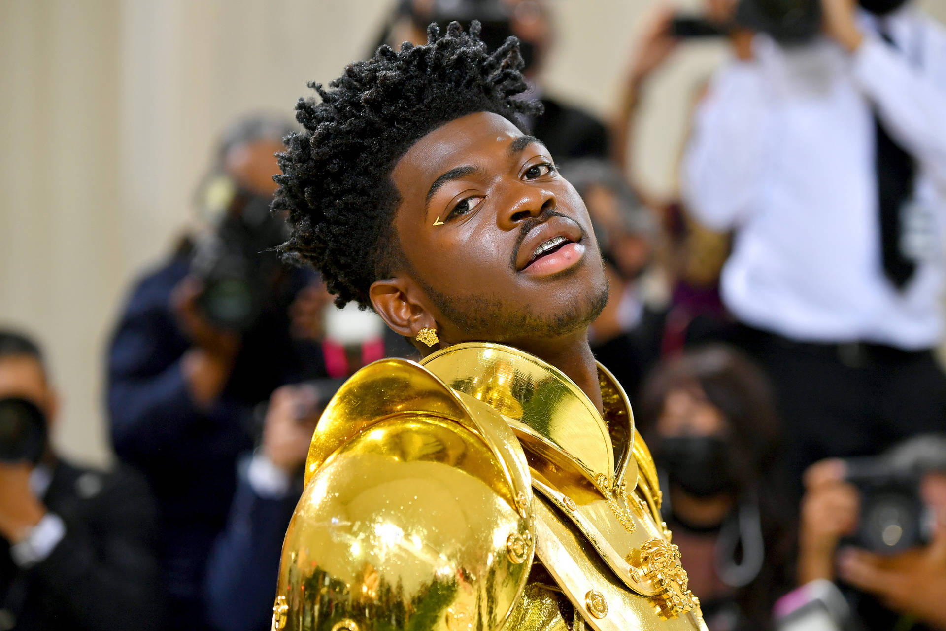 Lil Nas X Gold Armor Outfit Background