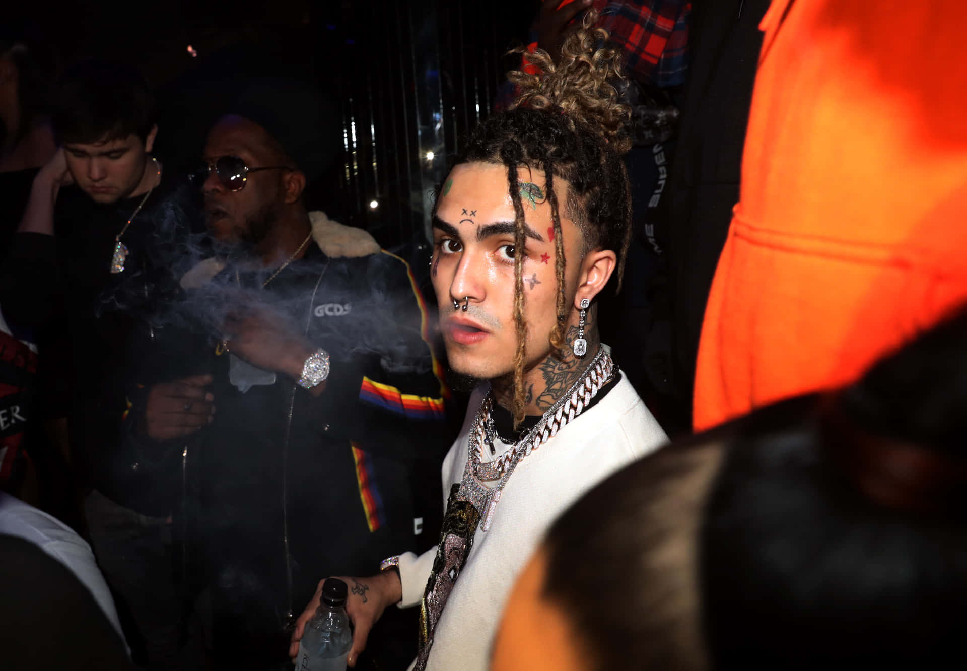 Lil Pump Standing Tall In Front Of A Crowd Background