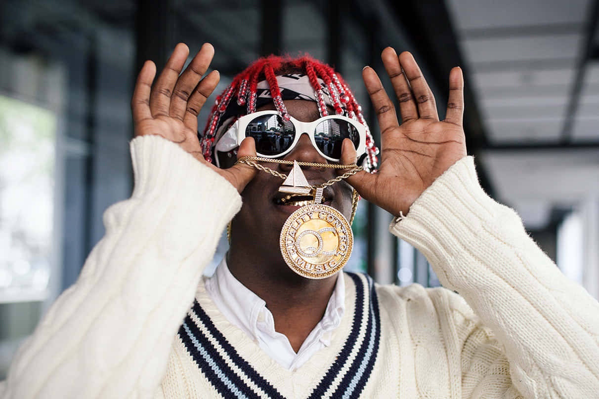 Lil Yachty Confidently Showing Off His Iconic Hairstyle Background