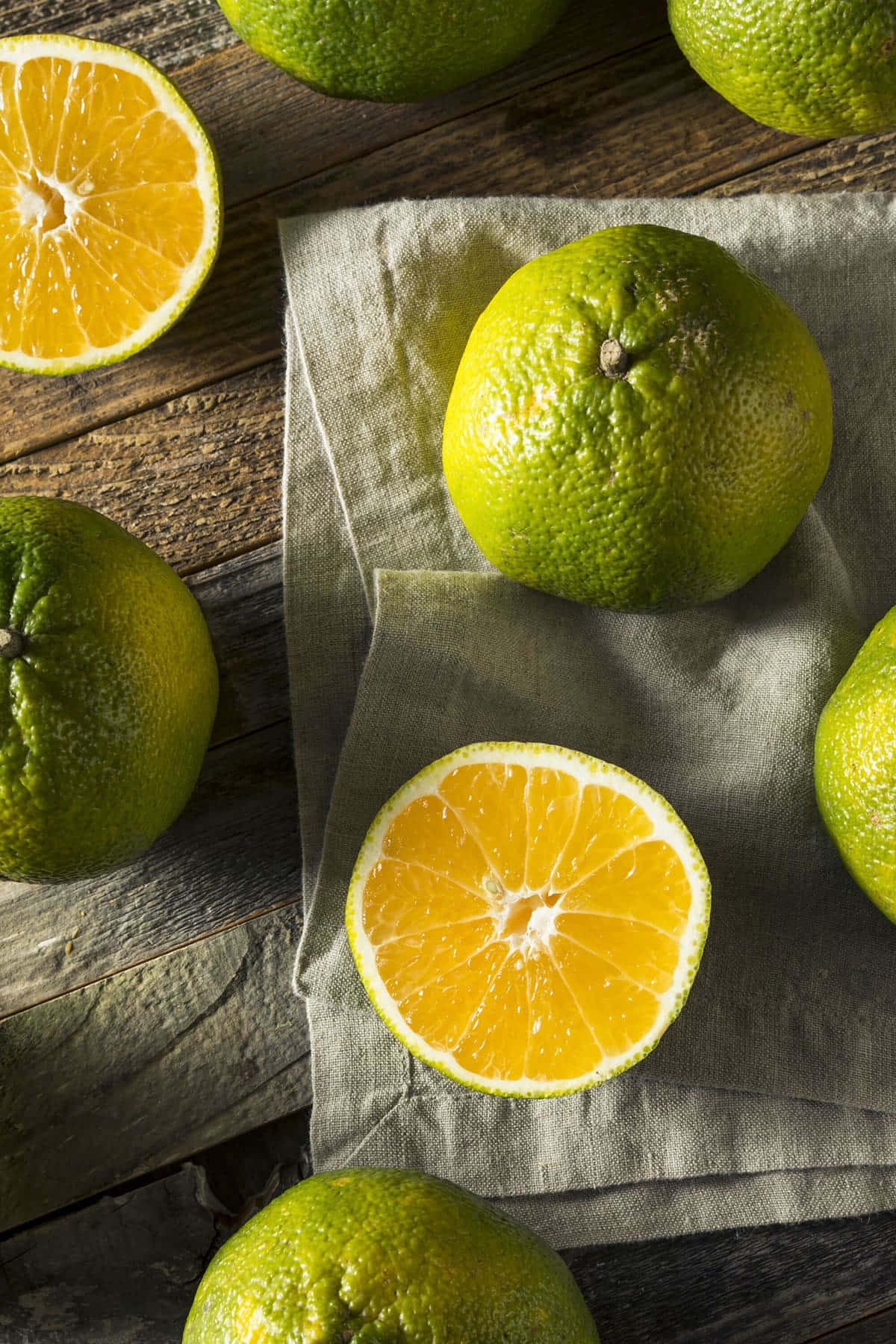 Lime Green Ugli Citrus Fruits And Slices Background