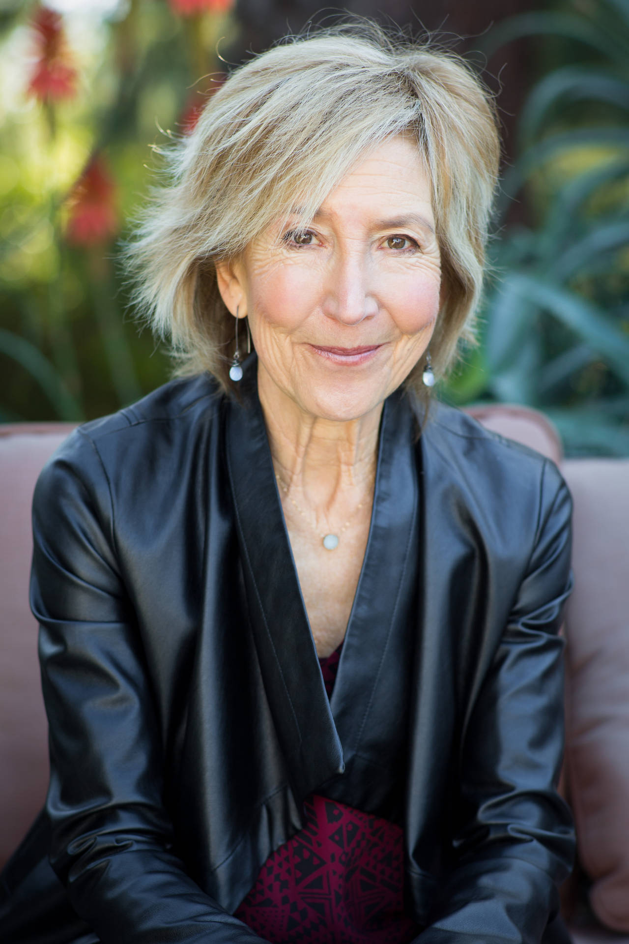 Lin Shaye On Brown Couch Background