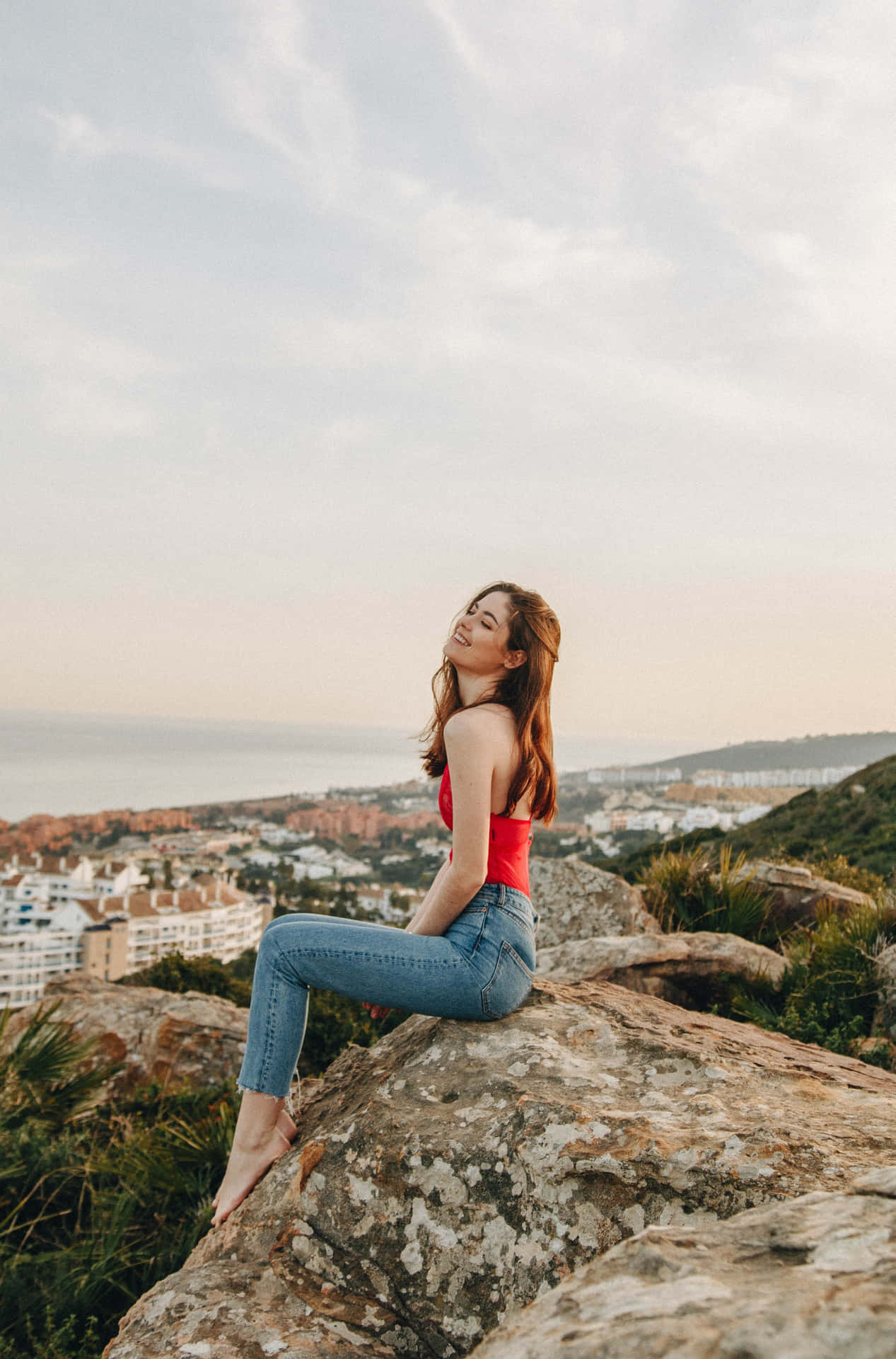 Linda Chica On A Cliff Background