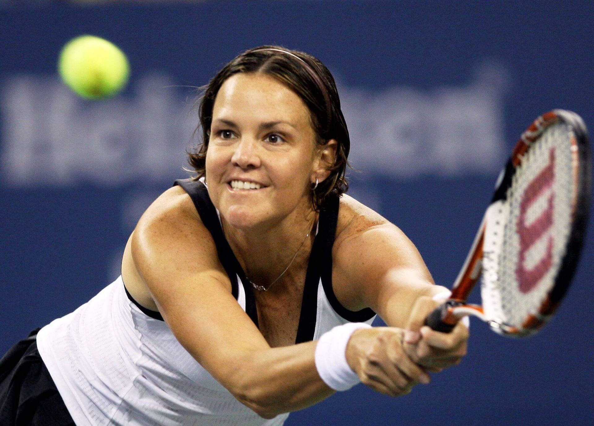 Lindsay Davenport Hitting Tennis Ball And Smiling Background