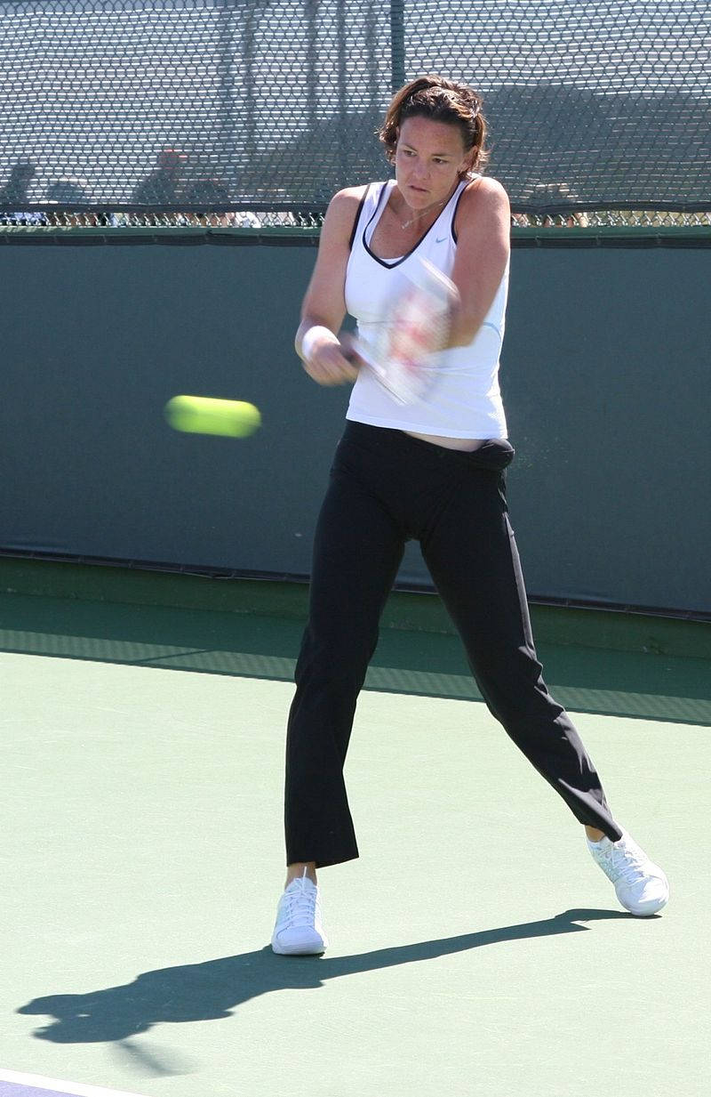 Lindsay Davenport Powerfully Hitting A Tennis Ball Background