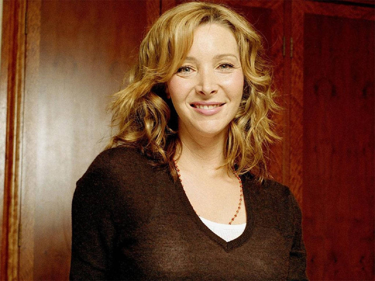 Lisa Kudrow Against Wood Wall Background