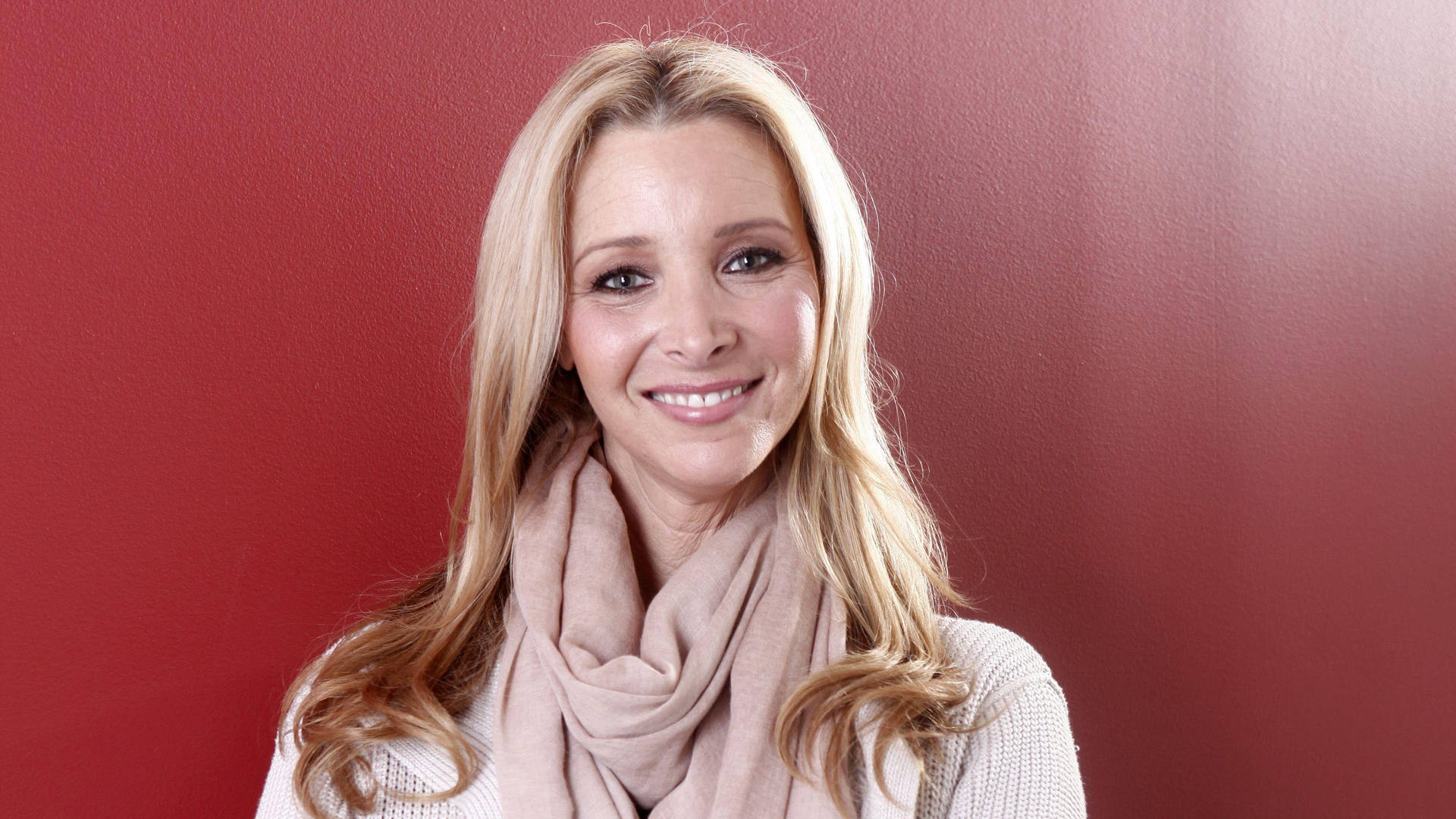 Lisa Kudrow In Crimson Wall Background