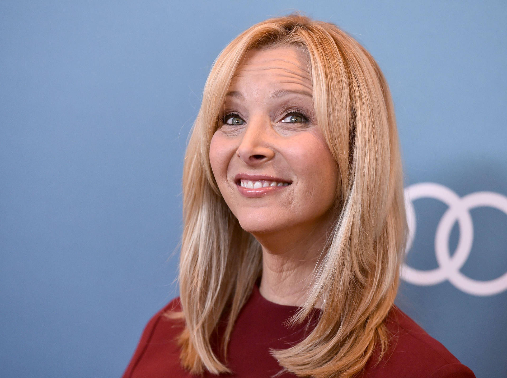 Lisa Kudrow In Red Outfit Background