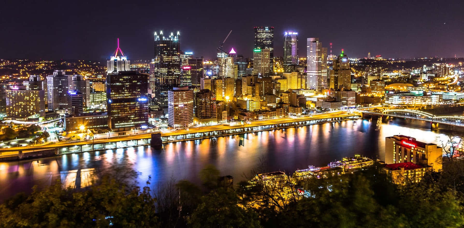 Lit-up Pittsburgh Skyline At Night Background