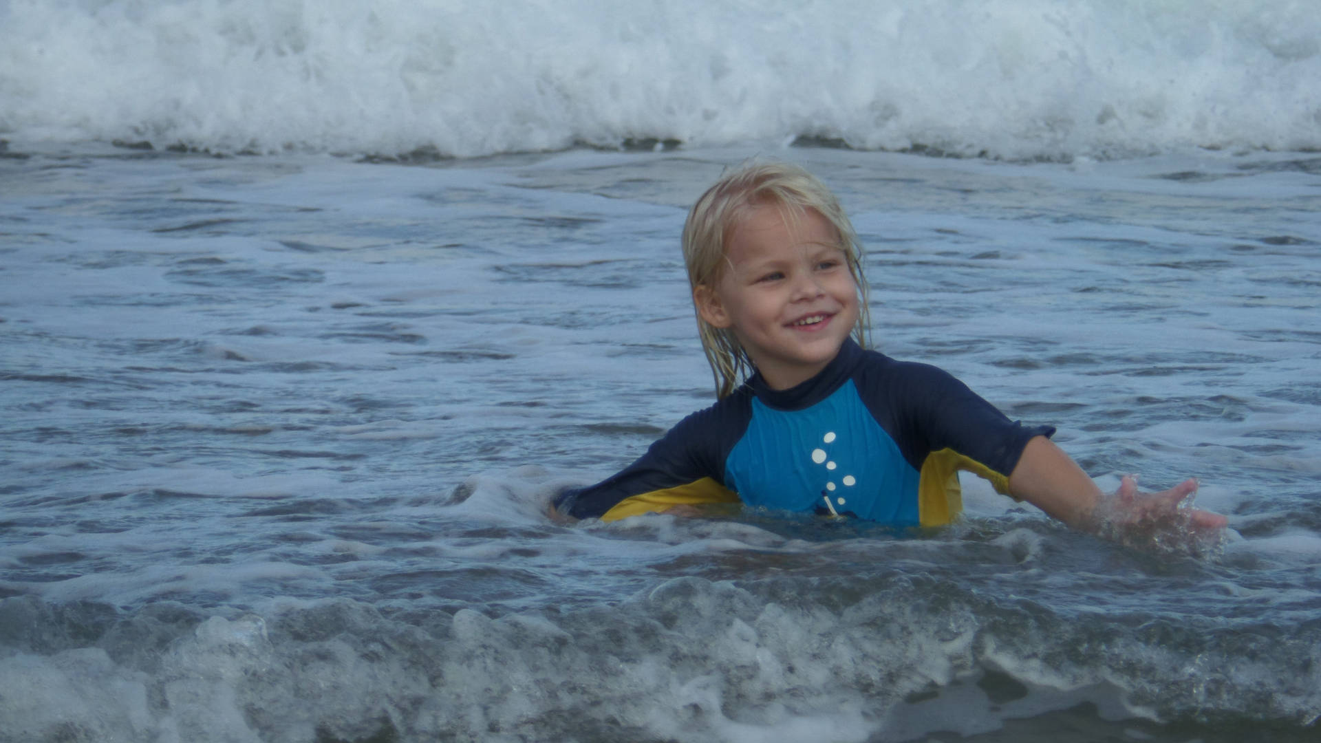 Little Boy Swimming In Beach Background