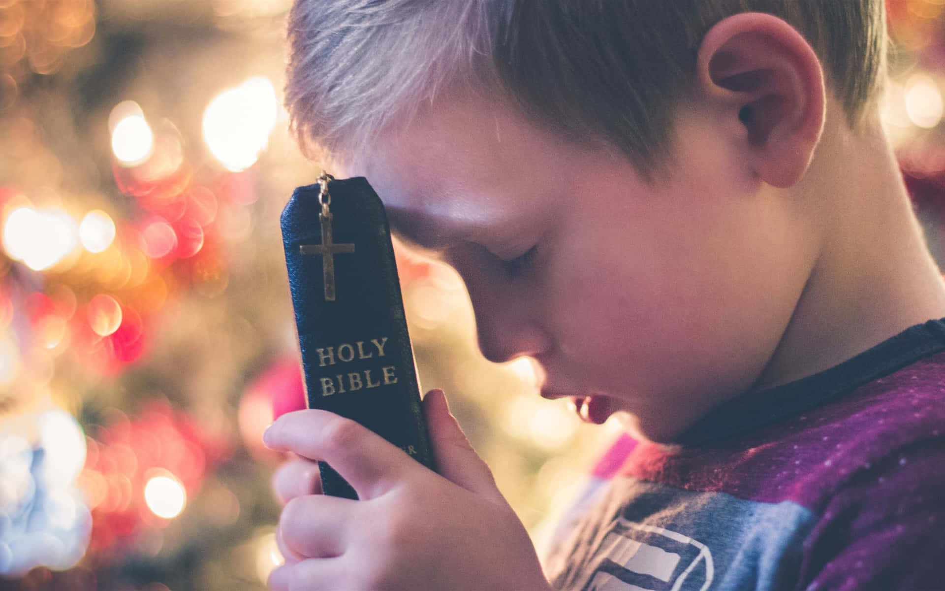 Little Child With Holy Bible Background