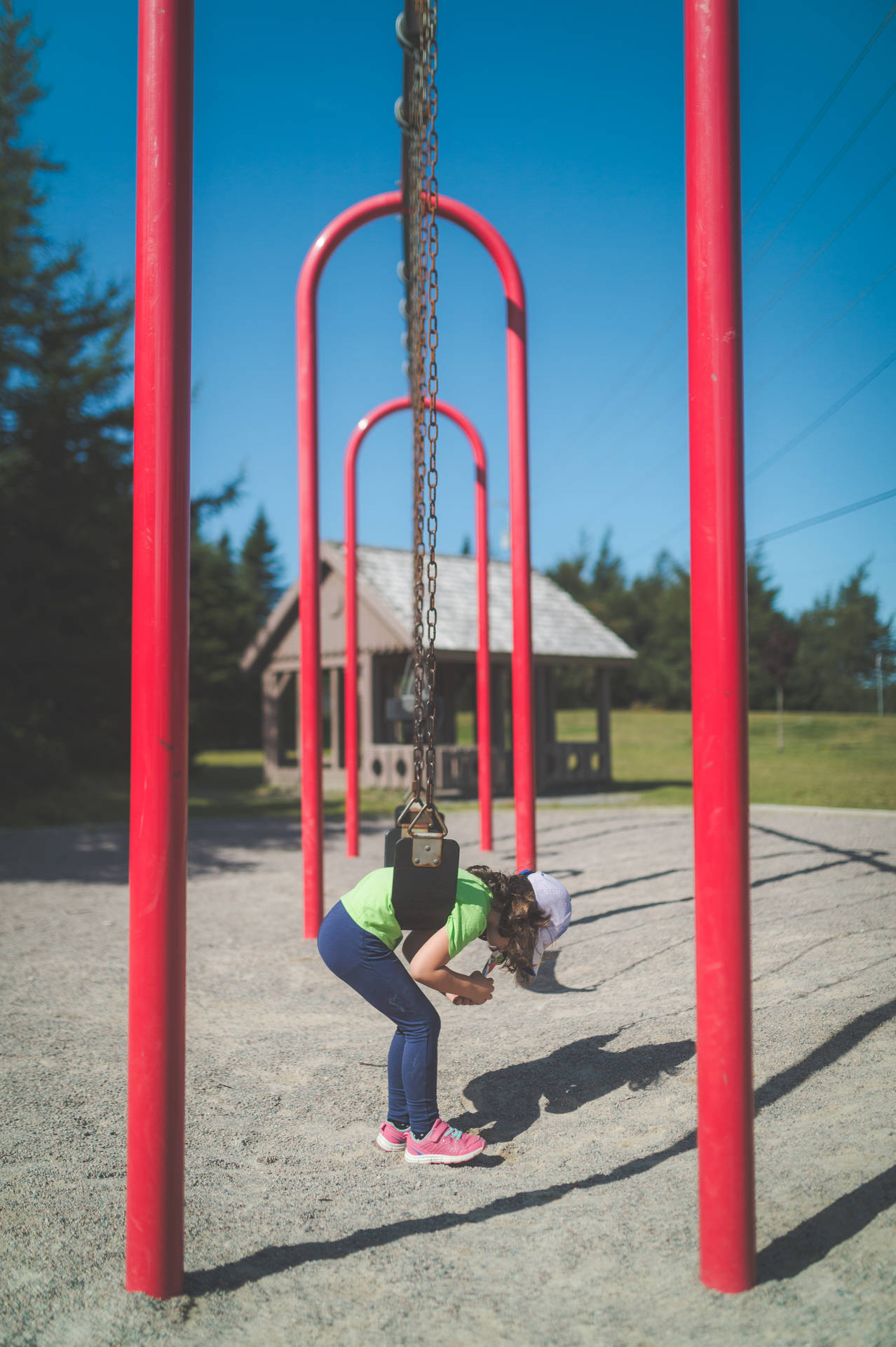 Little Girl On Playground Swing Background