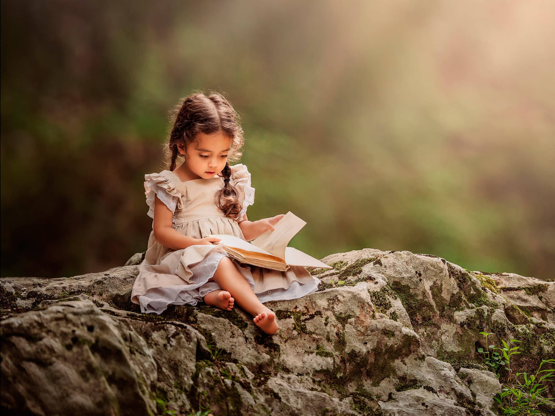 Little Girl Reading On Rock