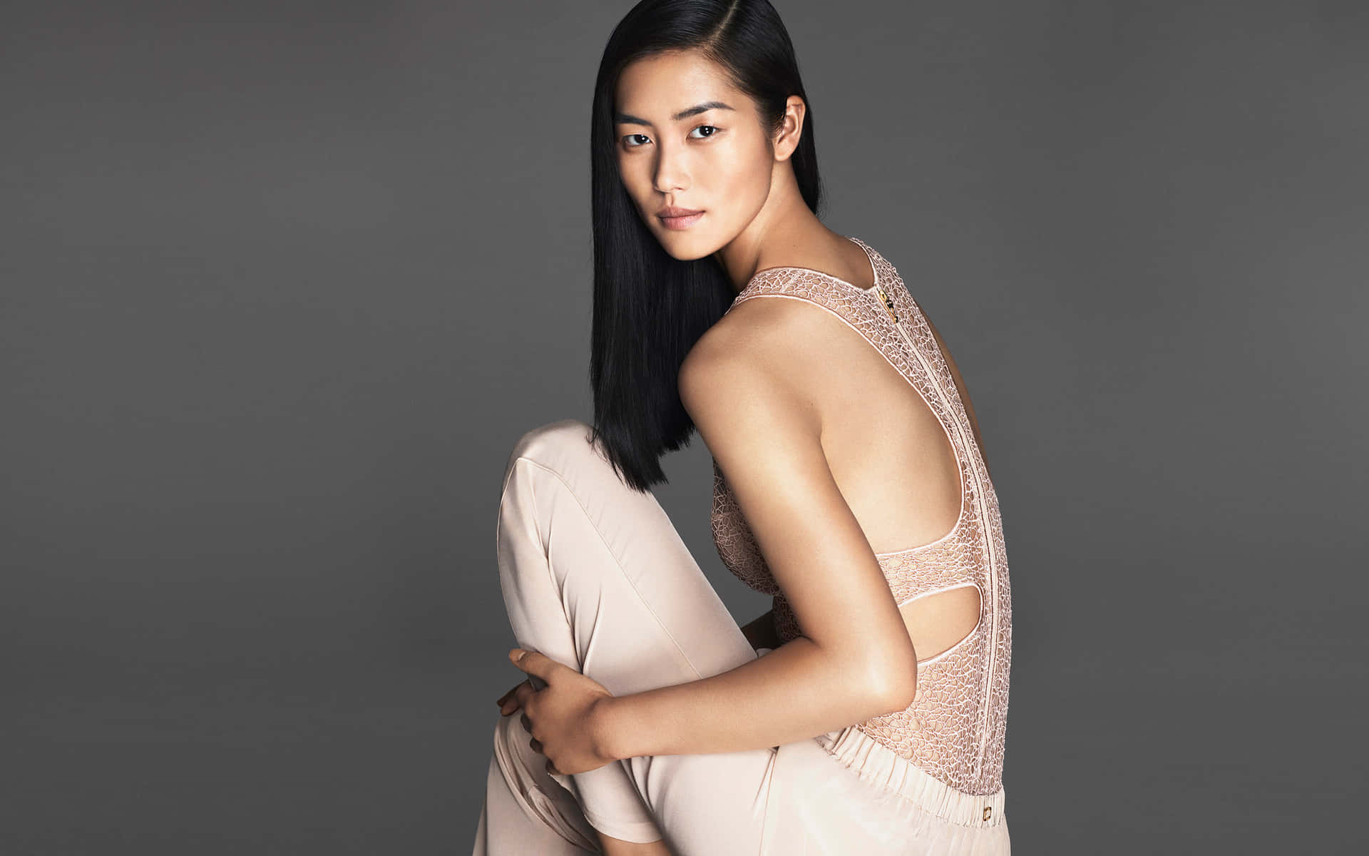 Liu Wen, International Supermodel, Striking A Pose During A Photo Shoot. Background