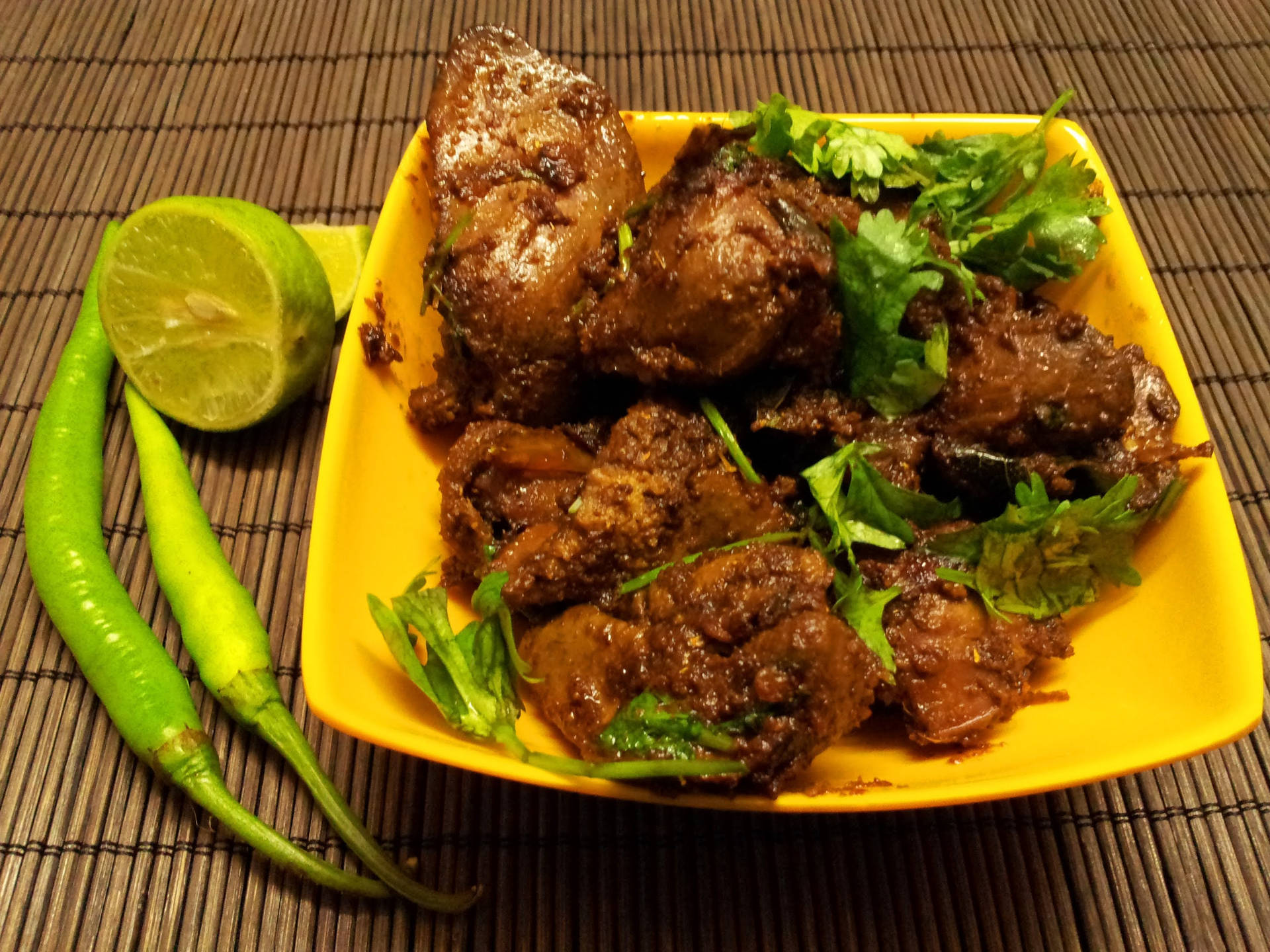 Liver With Basil Leaves On Yellow Plate Background