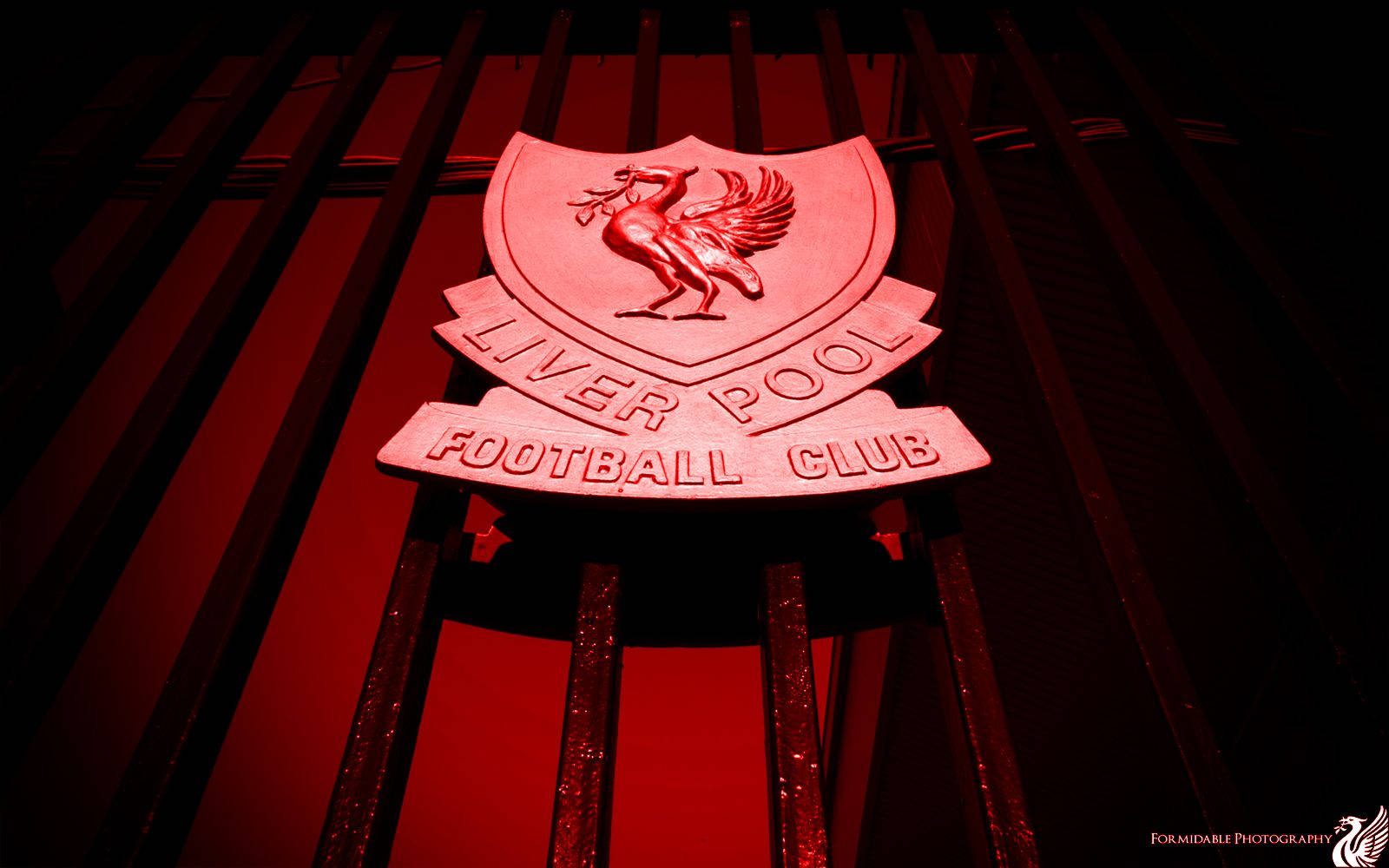 Liverpool Fc Logo At Anfield's Shankly Gates Background