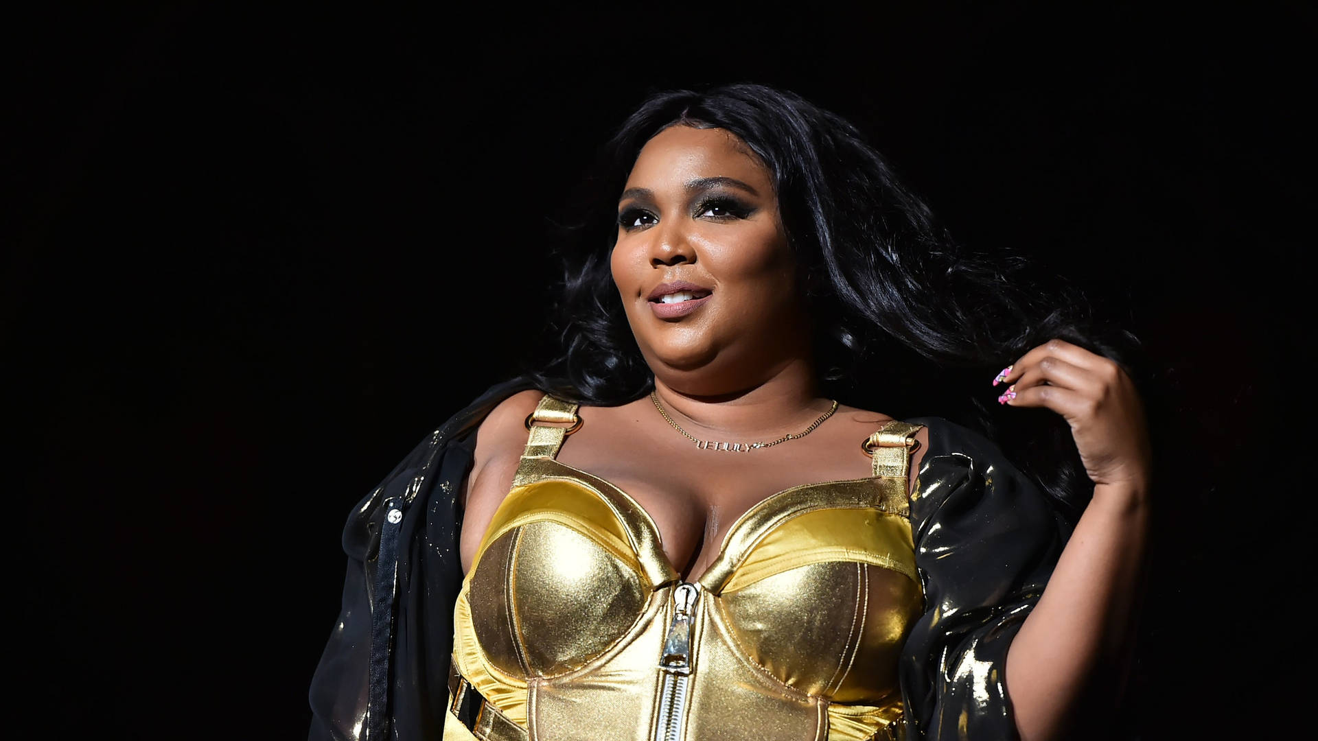 Lizzo Black And Gold Outfit Background