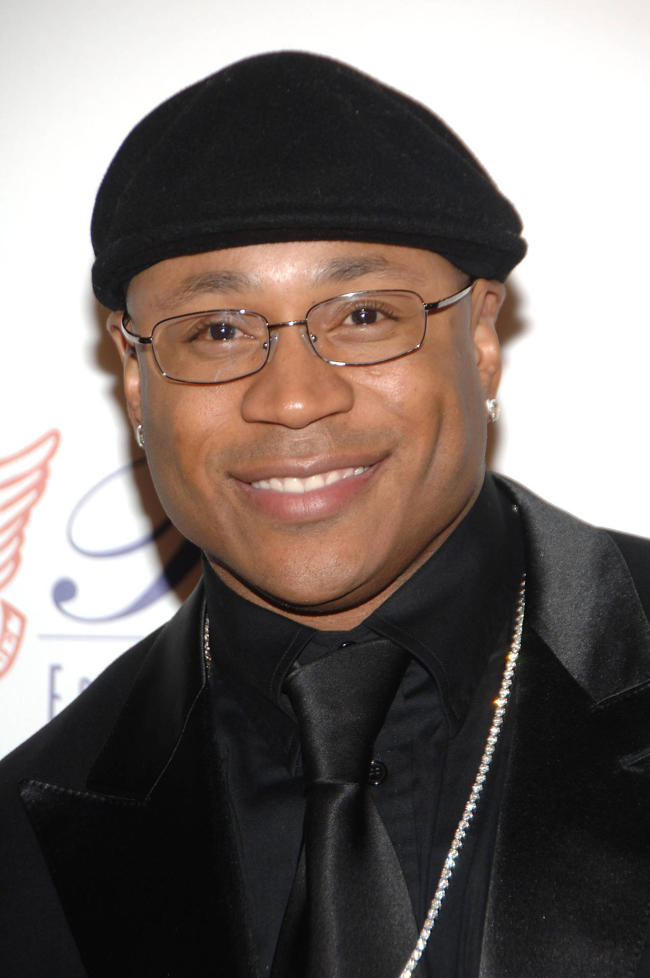 Ll Cool J With An All Black Suit And Beret Background