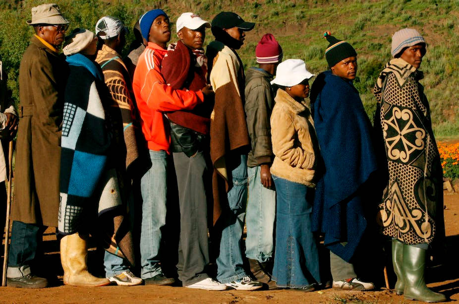 Local Lesotho Individuals In Caps And Jackets