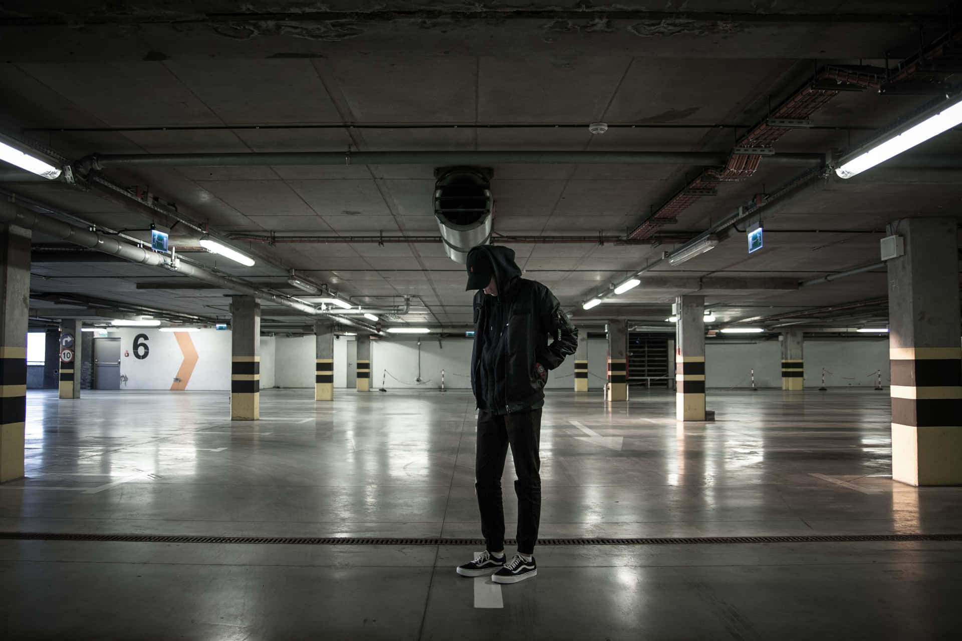 Lone Man In An Underground Parking Lot Background