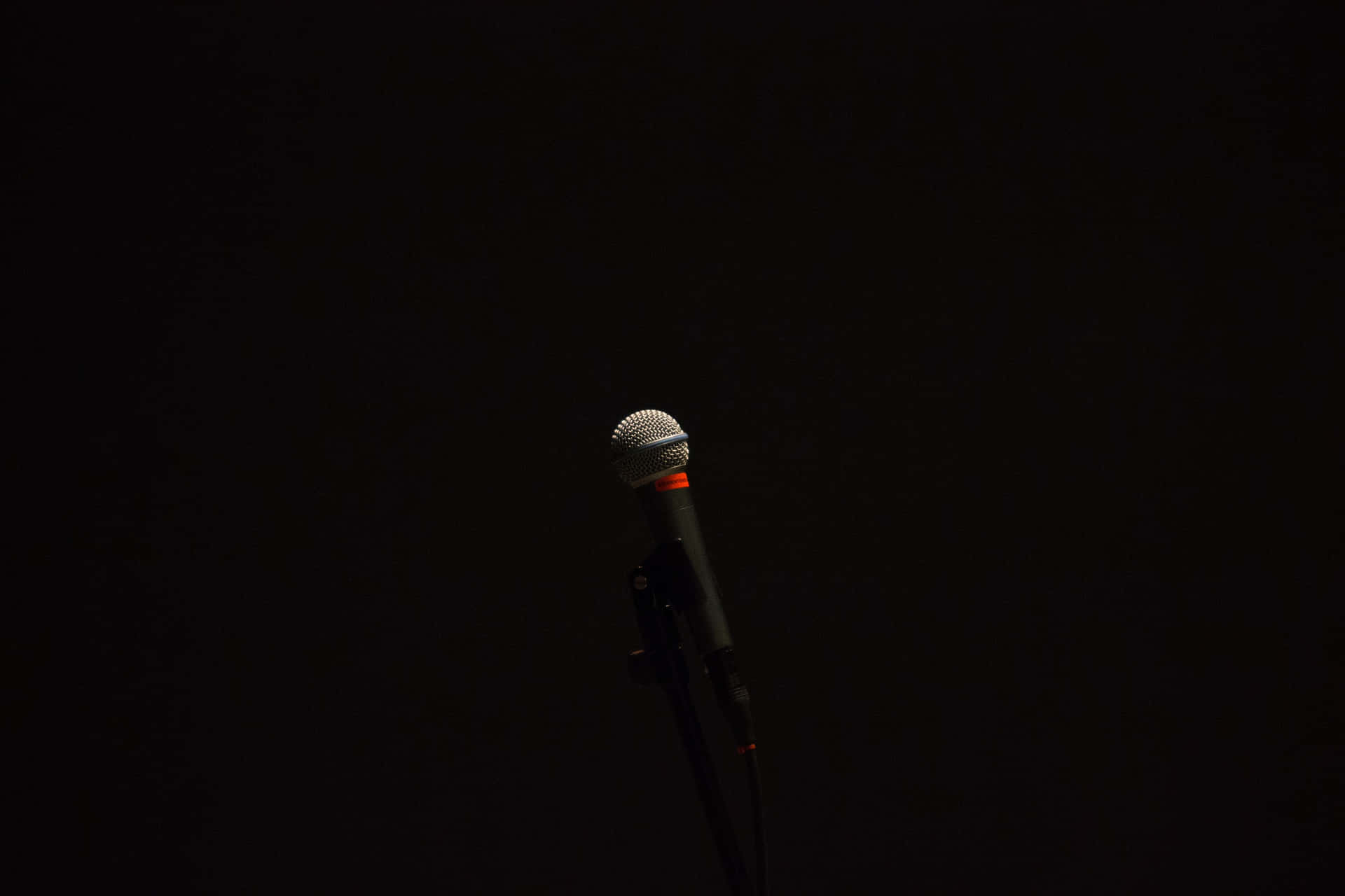 Lone Microphone In The Dark Background