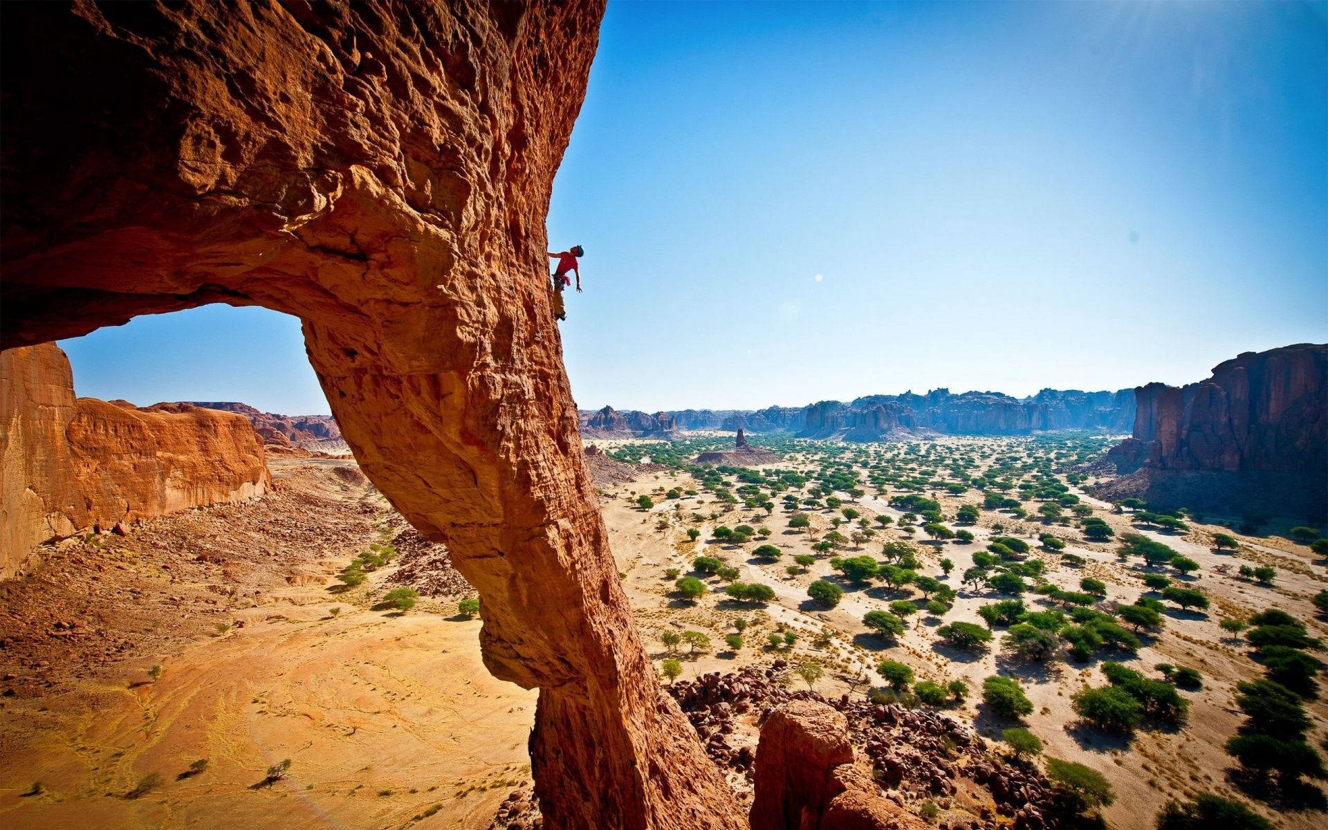 Long Shot Photo Of A Man Climbing Rock