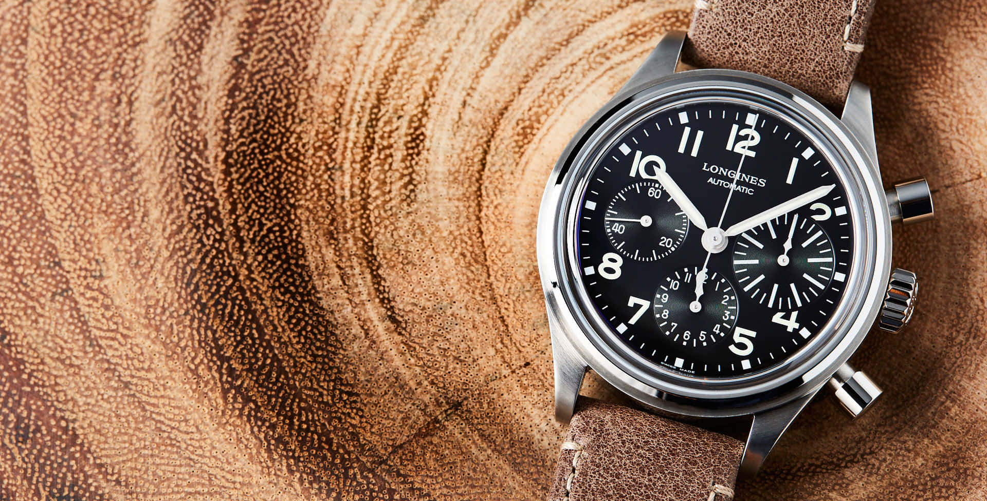 Longines Avigation Bigeye On A Tree Trunk Background Background