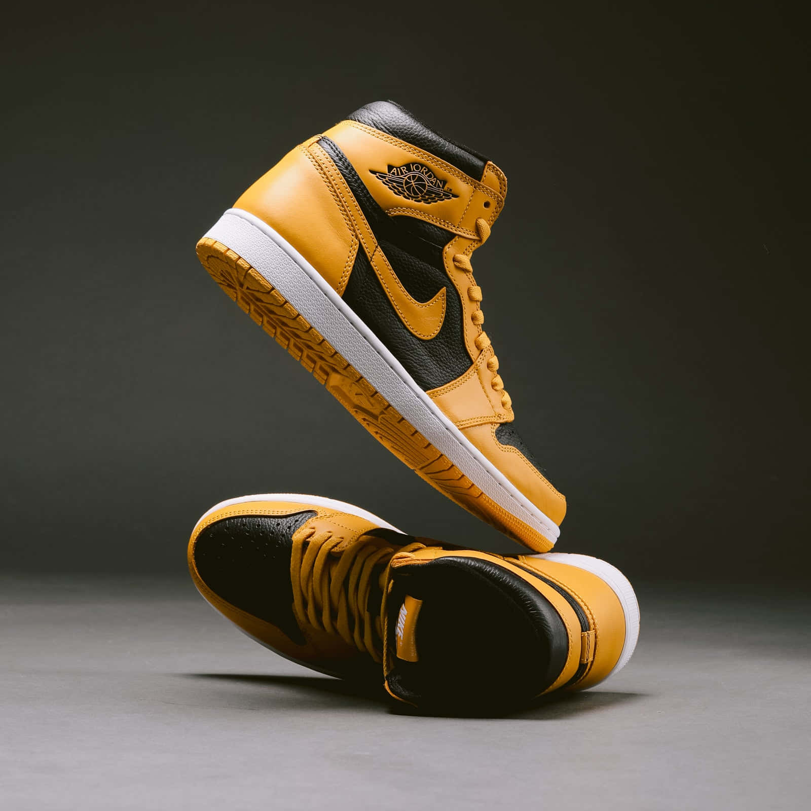 Look Stylish And Bold In The Classic Yellow Jordan Sneaker. Background