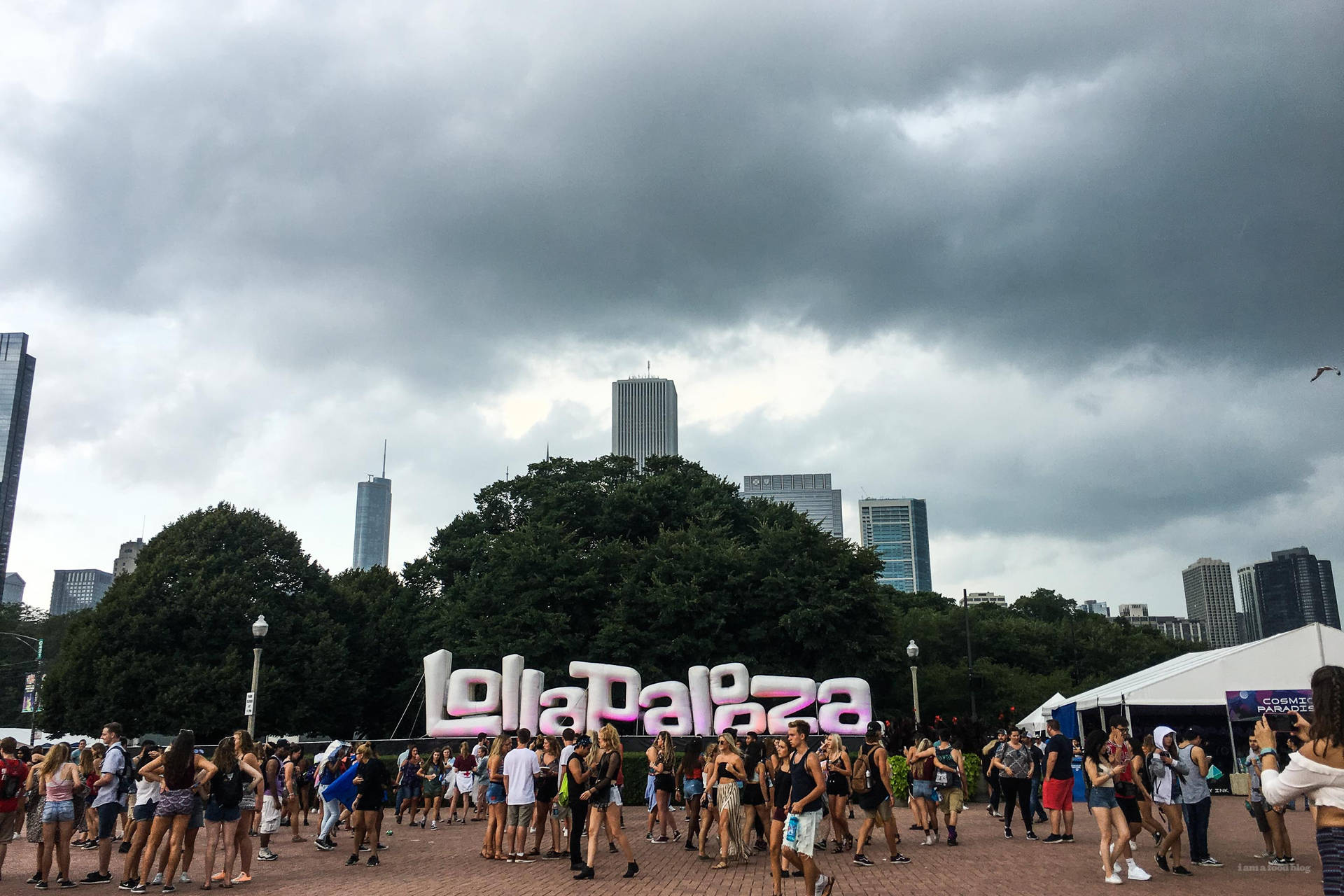 Looking Up Towards The Cloudy Chicago Skyline During The Annual Lollapalooza Music Festival Background