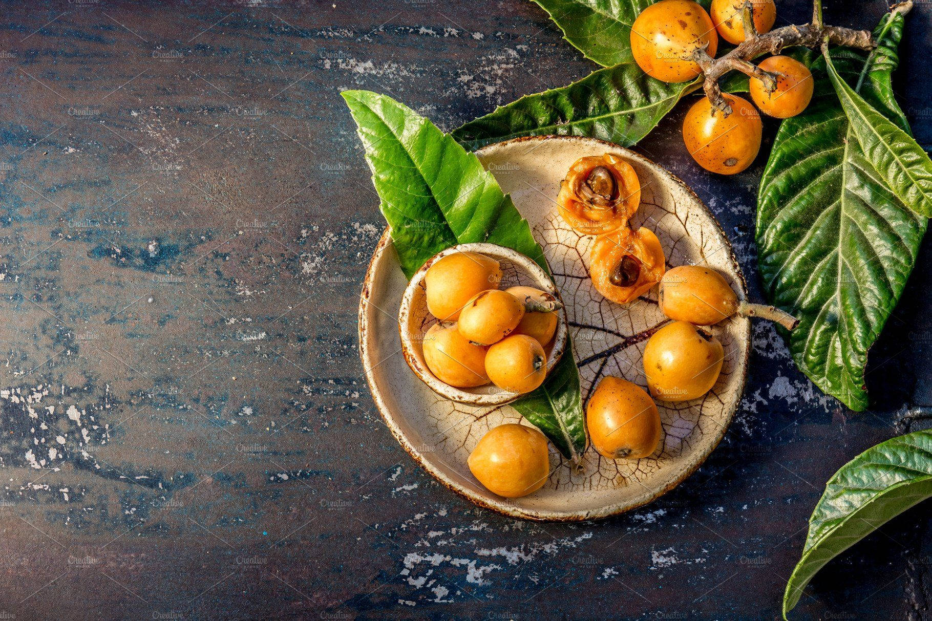 Loquat Fruit On Wooden Plate Background