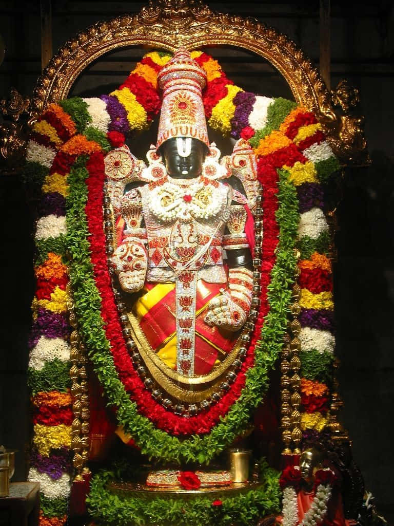 Lord Balaji Adornedin Flowersand Jewelry Background