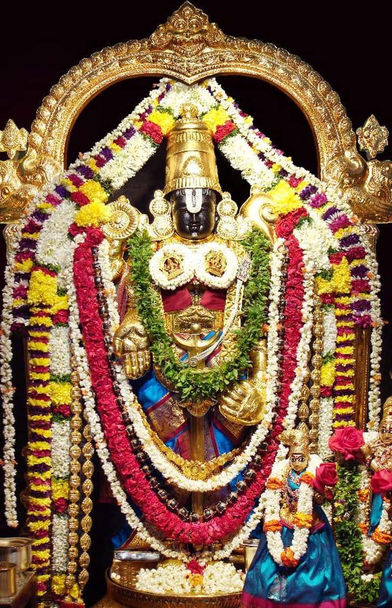 Lord Balaji Adornedin Flowersand Jewelry Background