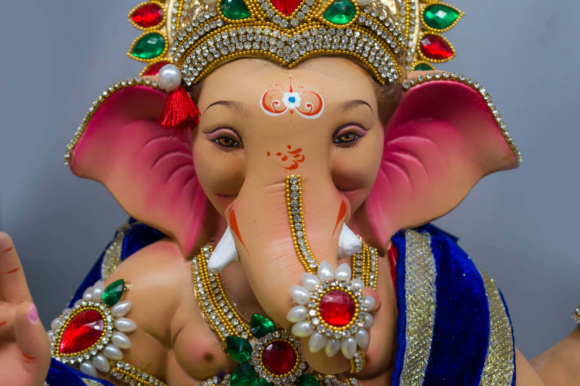 Lord Ganesha Statue Adornedin Jewels Background