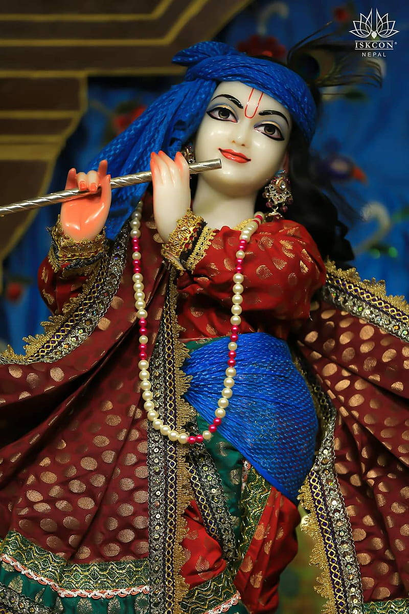 Lord Krishna Adorned In Royal Attire At Iskcon Temple Background