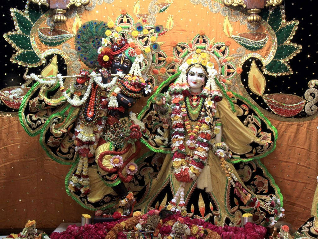 Lord Krishna And Radha In Iskcon Temple Background