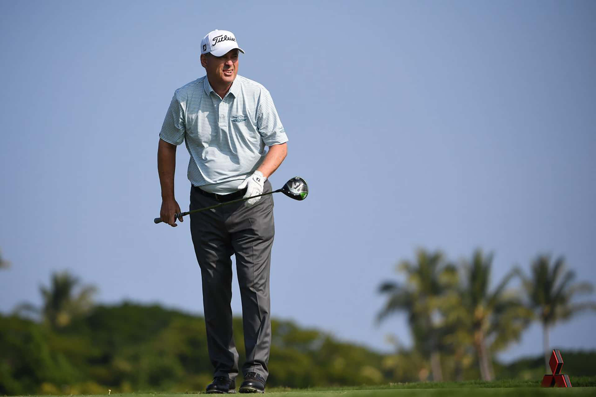 Loren Roberts Standing On Golf Course Background